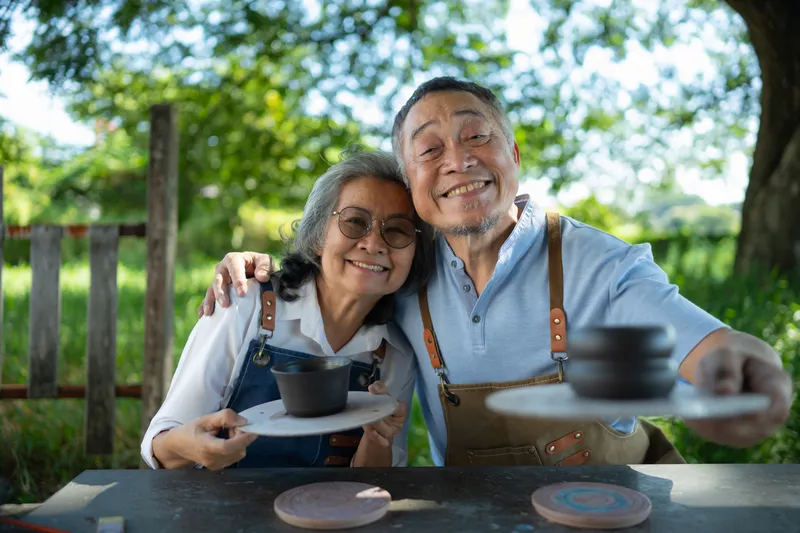 Retired couple walking along a waterfront path