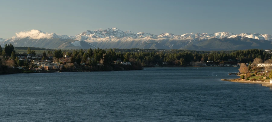 Silverdale waterfront at sunset with Olympic Mountains in distance
