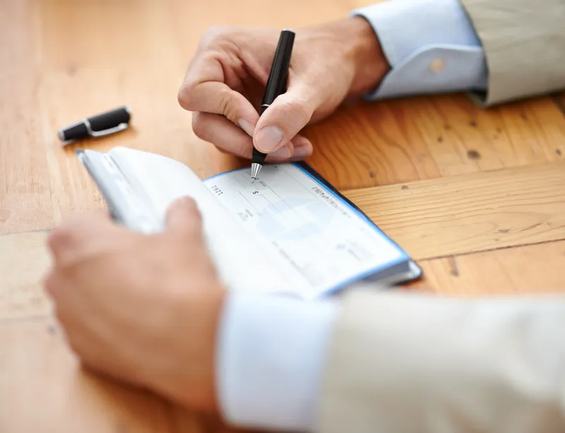 Signing a check for apartment deposit